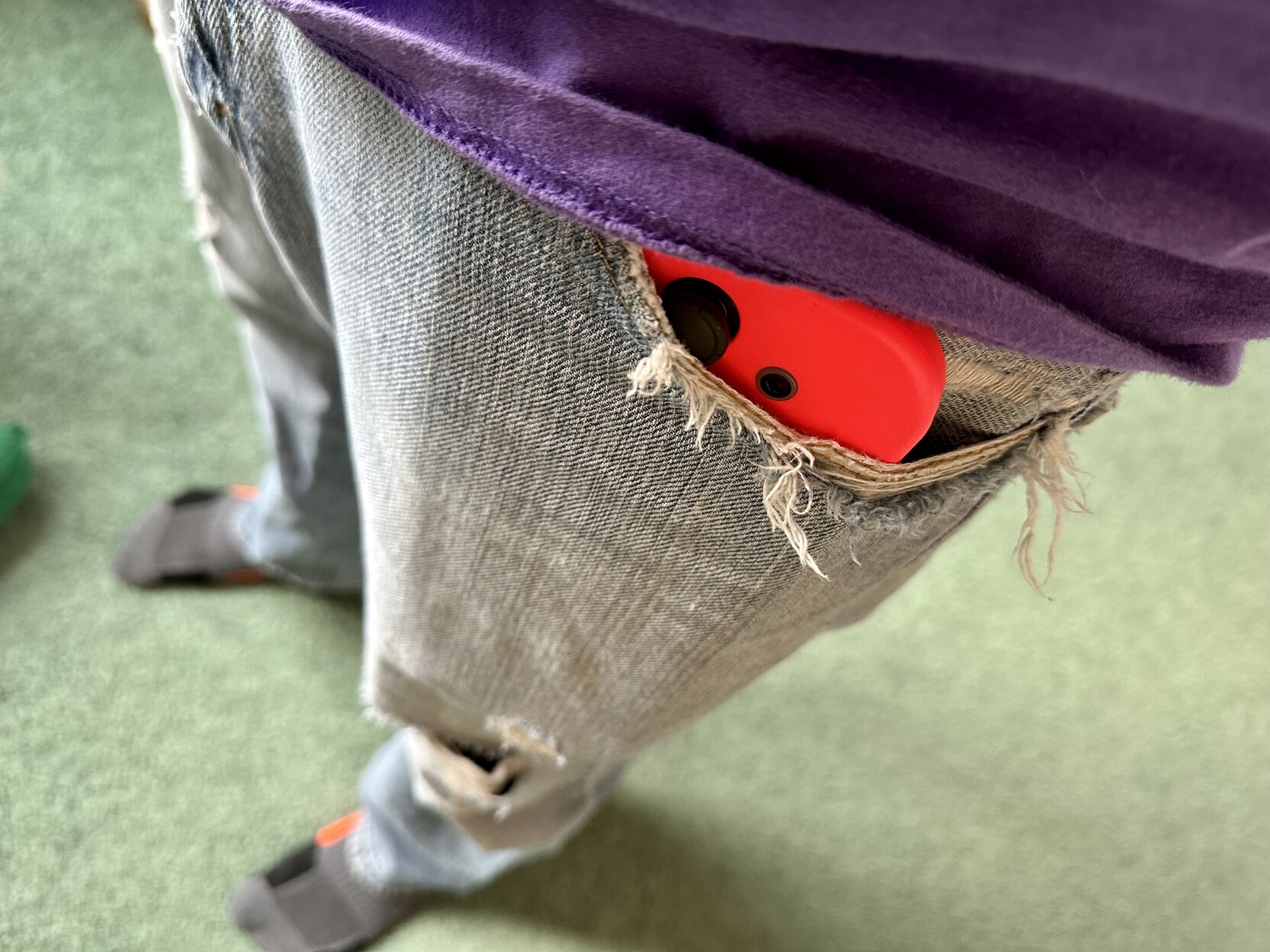 a photo of me with a Nintendo Switch in my jeans pocket.