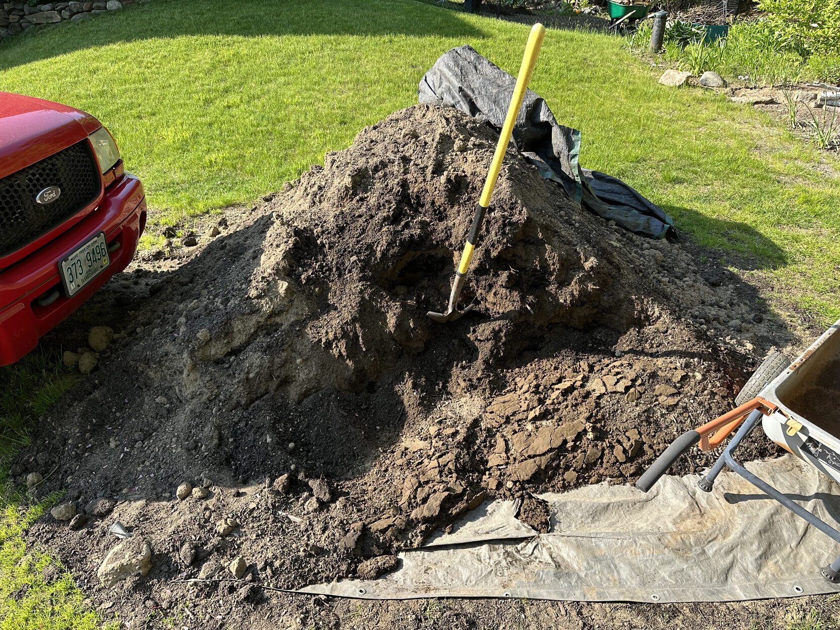 a photo of a pile of dirt that started out as 4 cubic yards, but i’ve hauled 20 wheelbarrows worth away. 