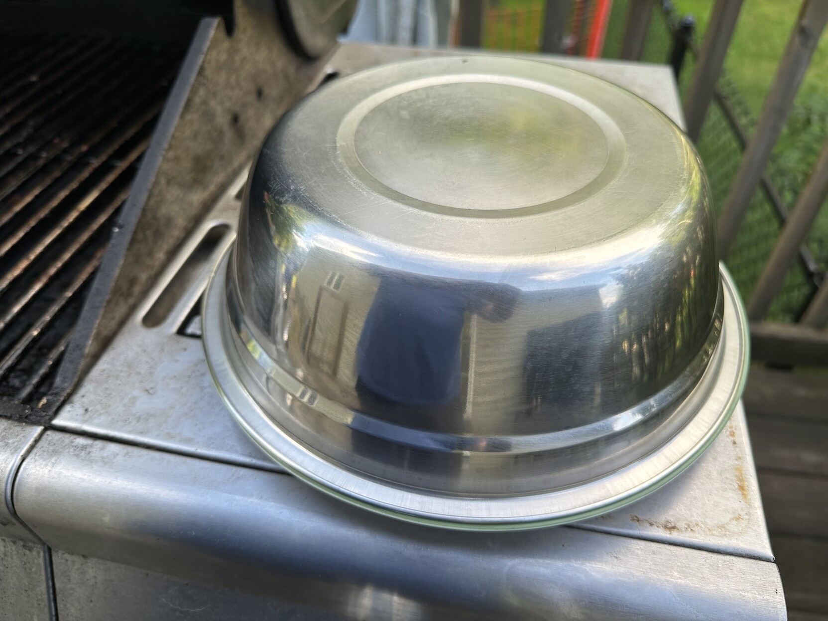 a photo of a plate covered by a stainless steel prep bowl 