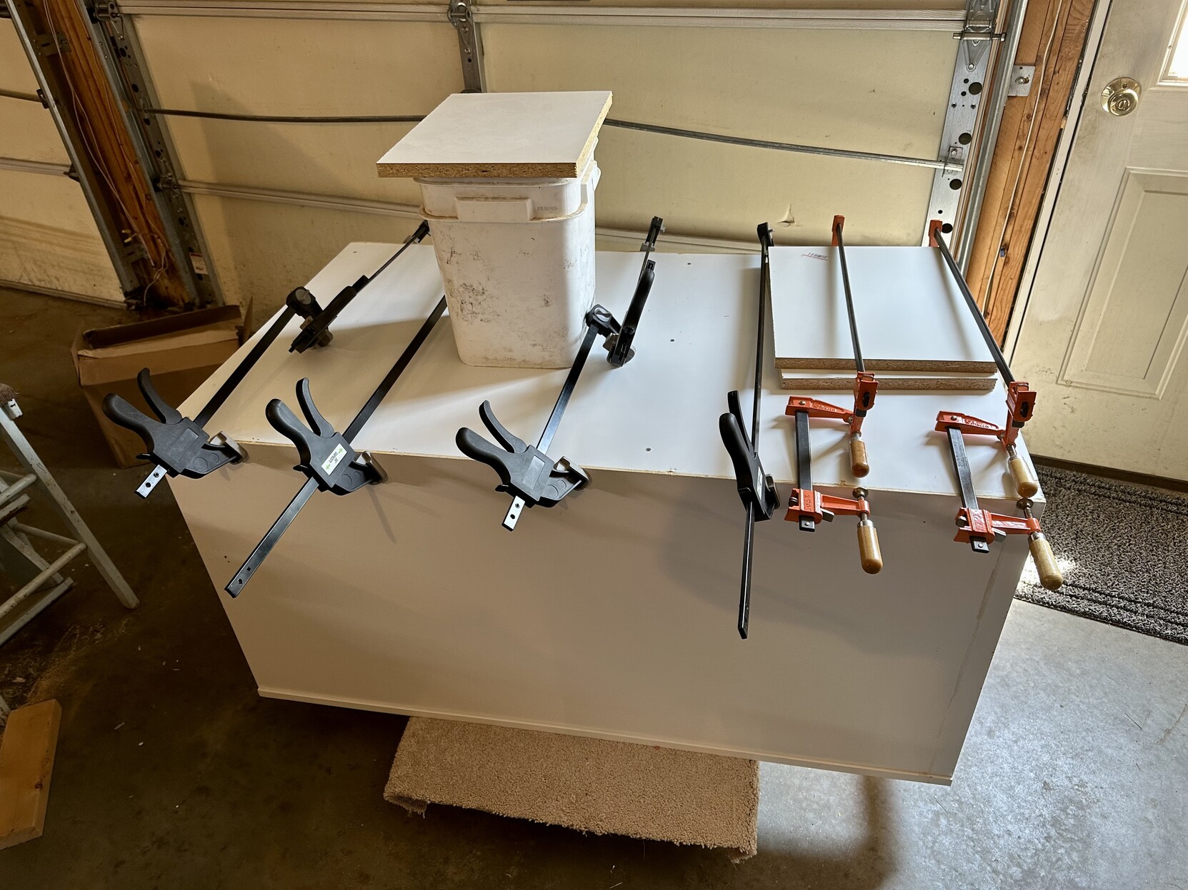 a photo of a cabinet i am gluing with many clamps holding it while the glue dries