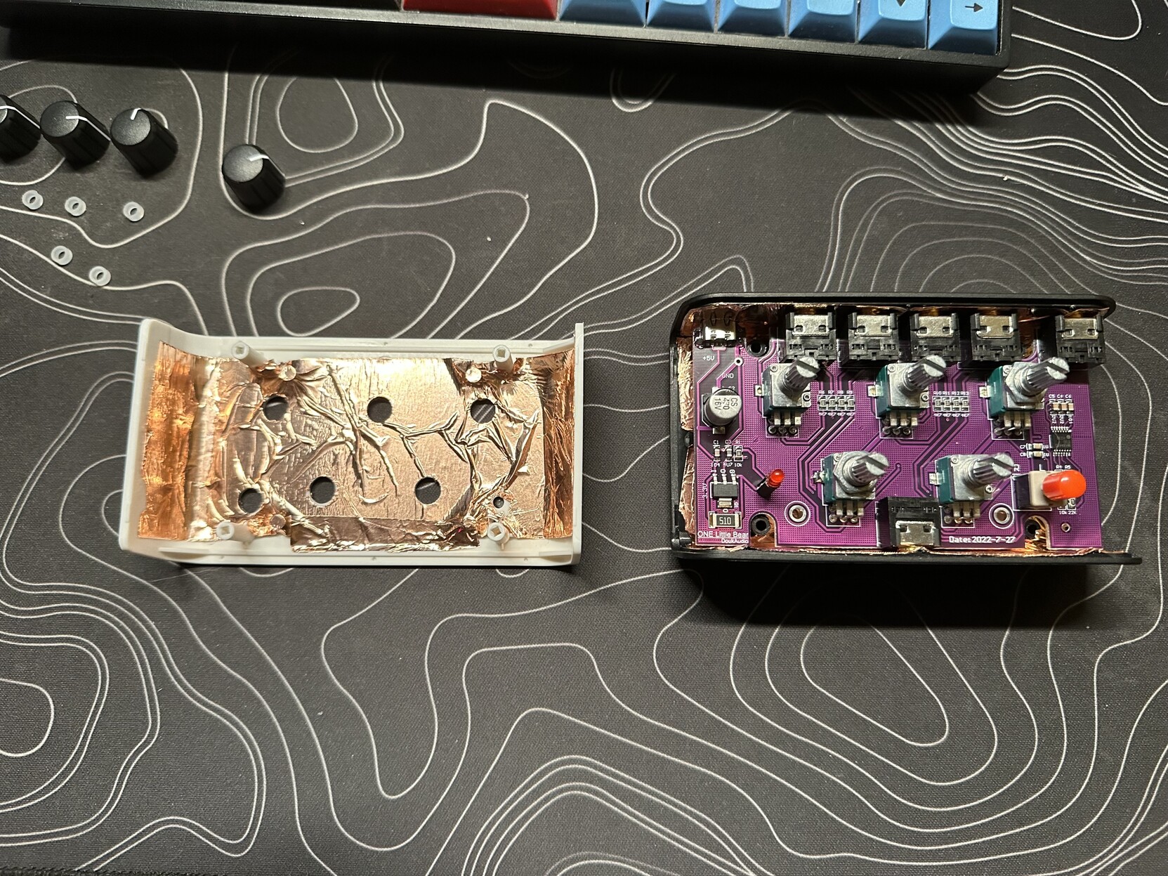 a photo of the circuit board reinstalled in the bottom half of the mixer and shielding tape applied inside the top half of the case