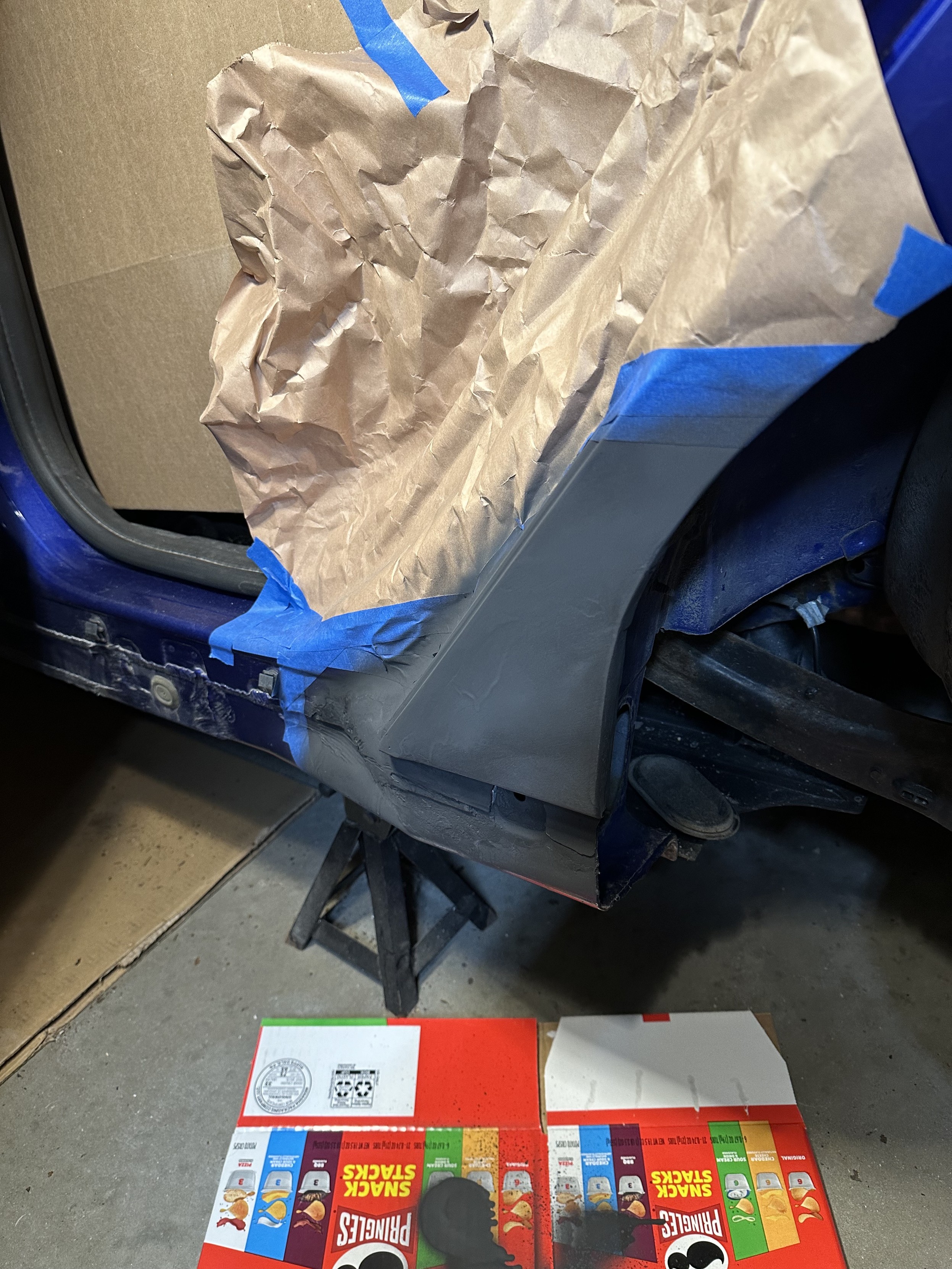 a photo of the lower quarter panel of my car with the area primed