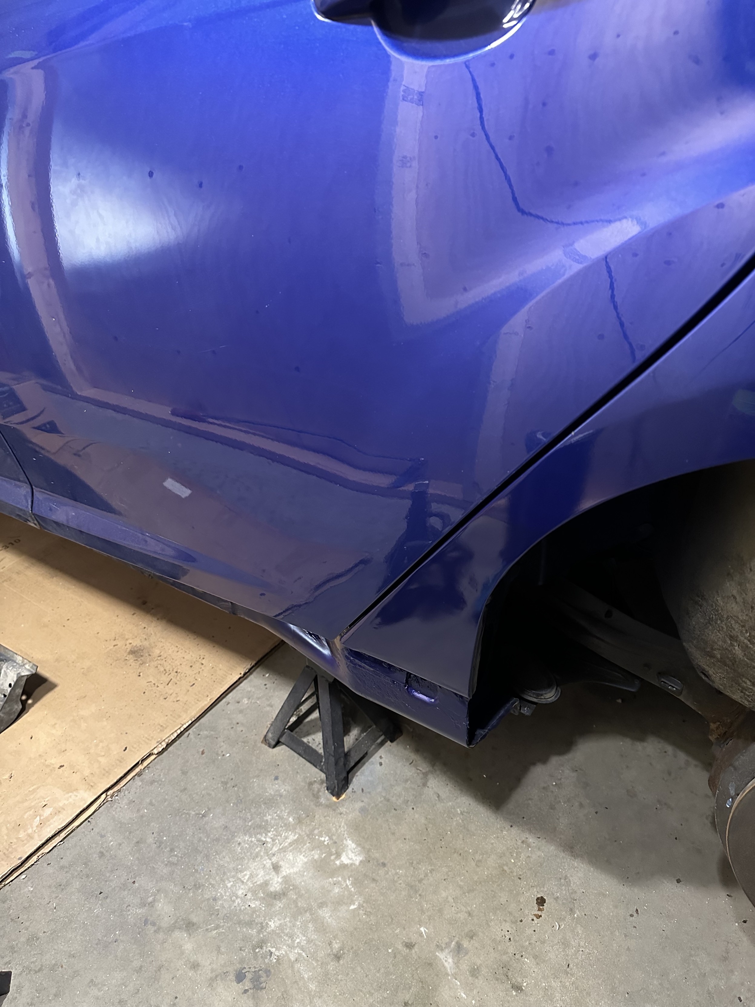 a photo of my car, where i replaced the rusted-out bottom of the quarter panel on the drivers side with a metal patch panel that i fabricated, installed, and painted.