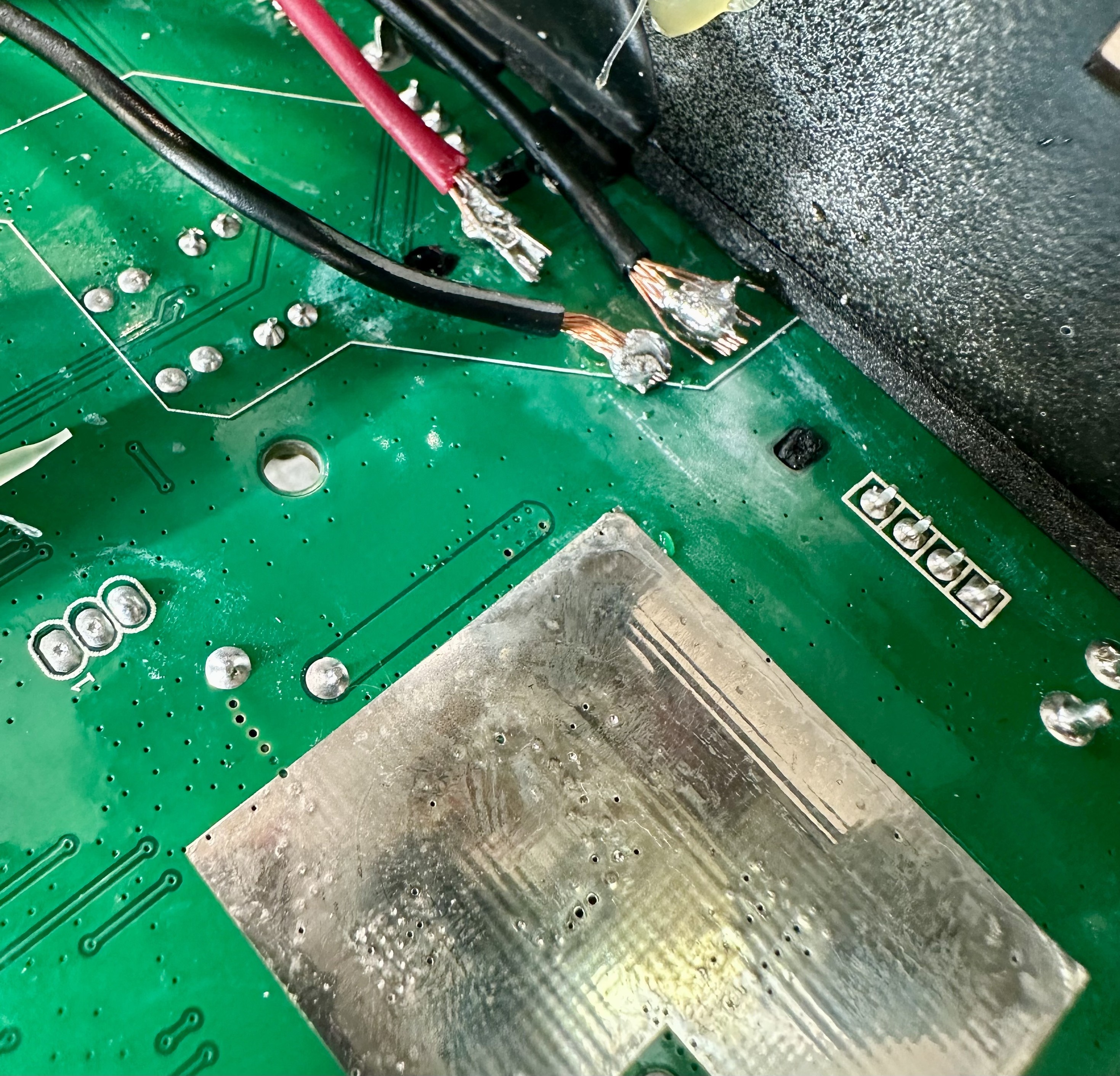 wires soldered onto pins sticking through the back of a circuit board