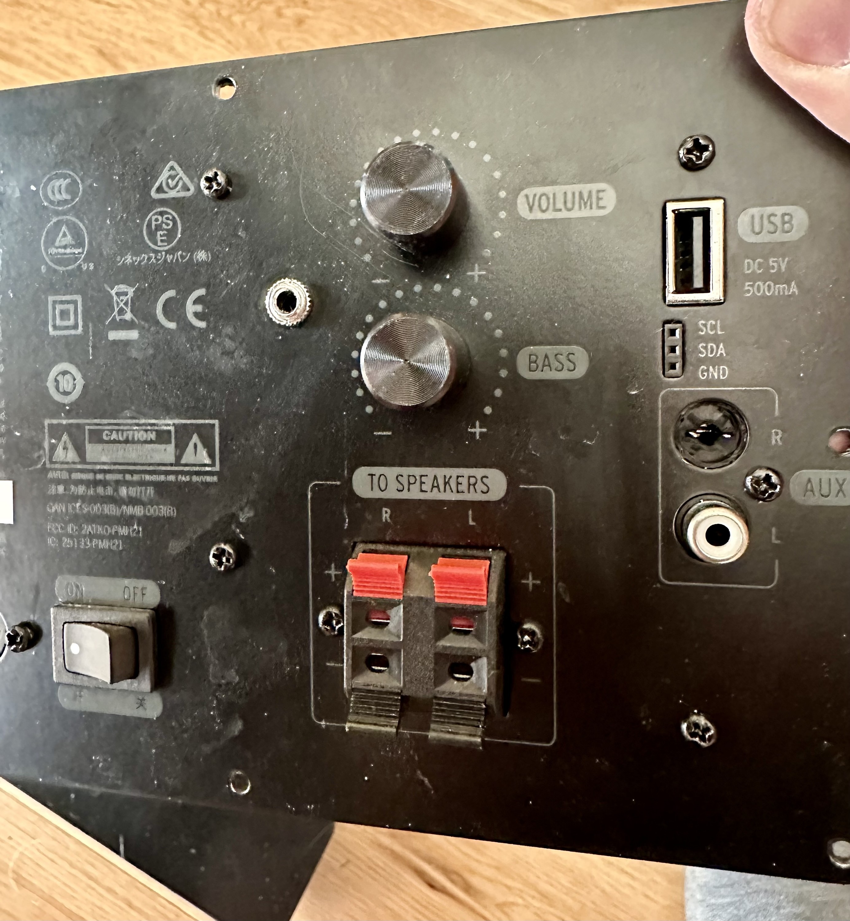 the back of the speaker showing the broken RCA jack and the newly installed 1/8” jack 