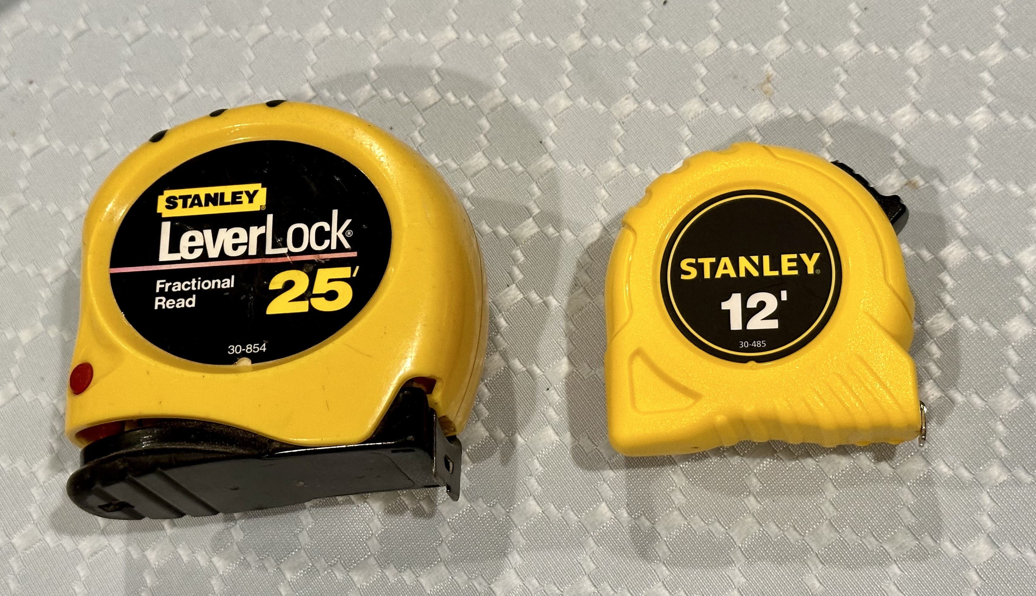 a photo of two tape measures; one large and one small. 