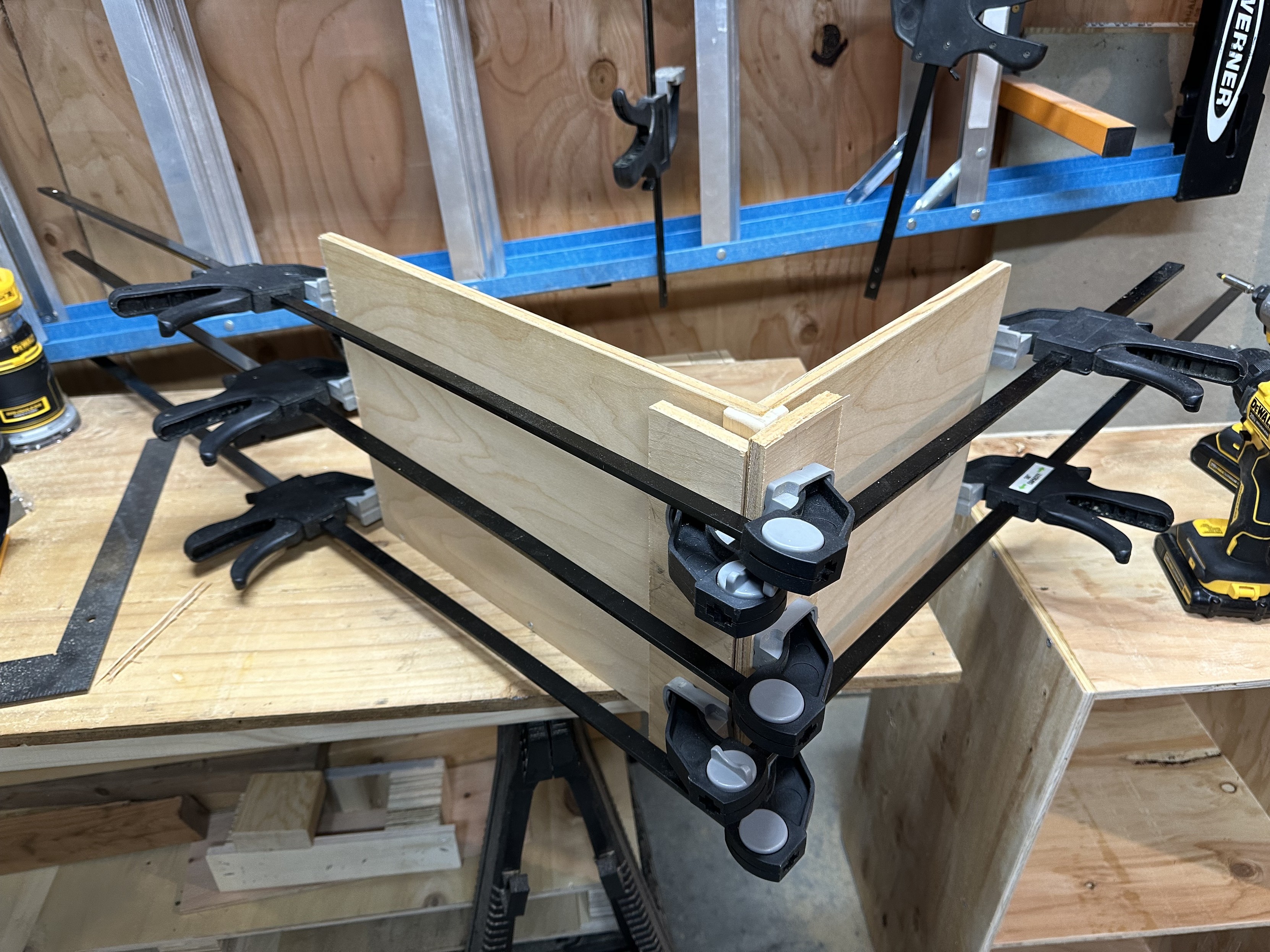 a photo of a plywood half box, glued and clamped up on my workbench