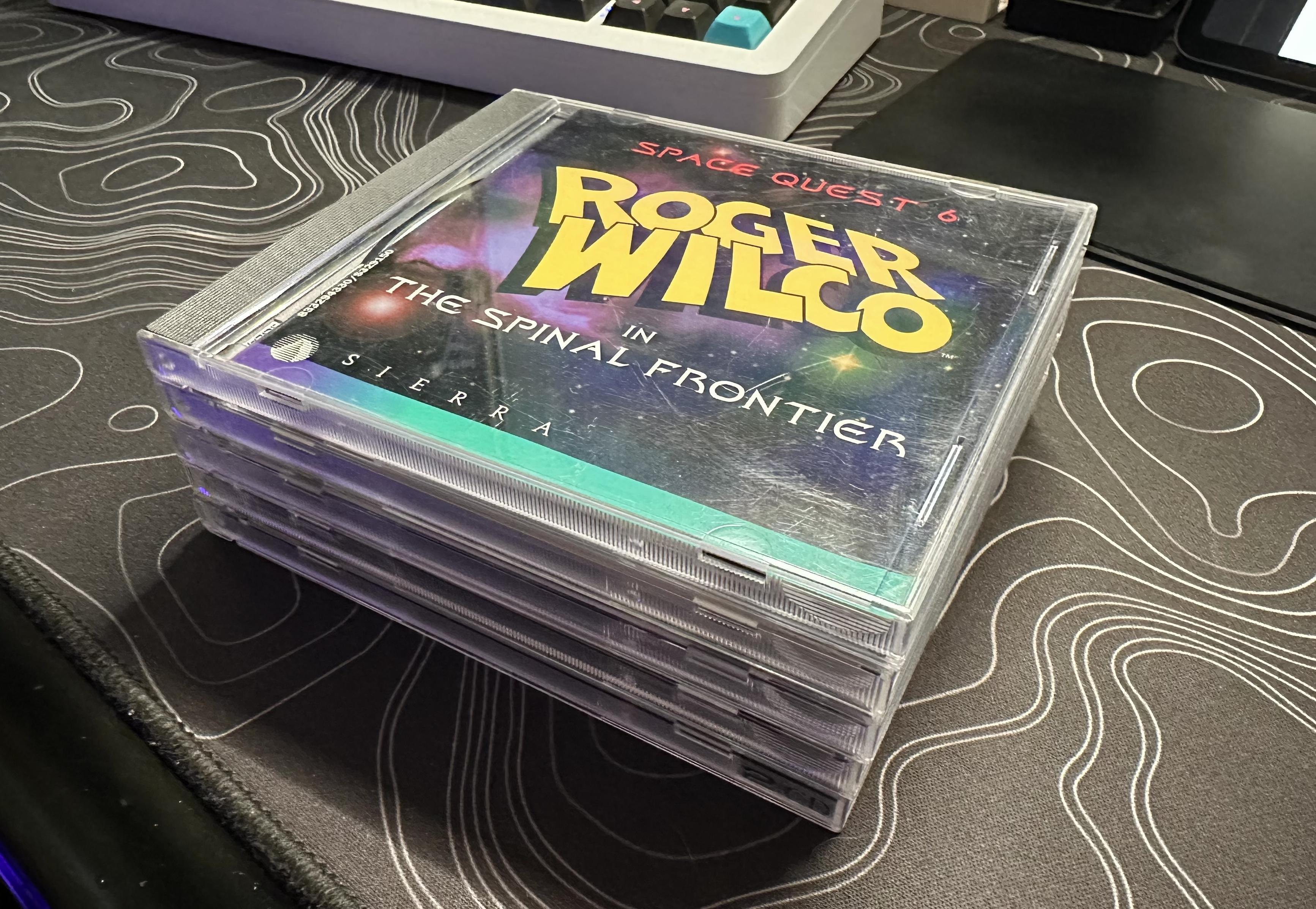 a photo of a stack of five CDs/DVDs in their cases. 