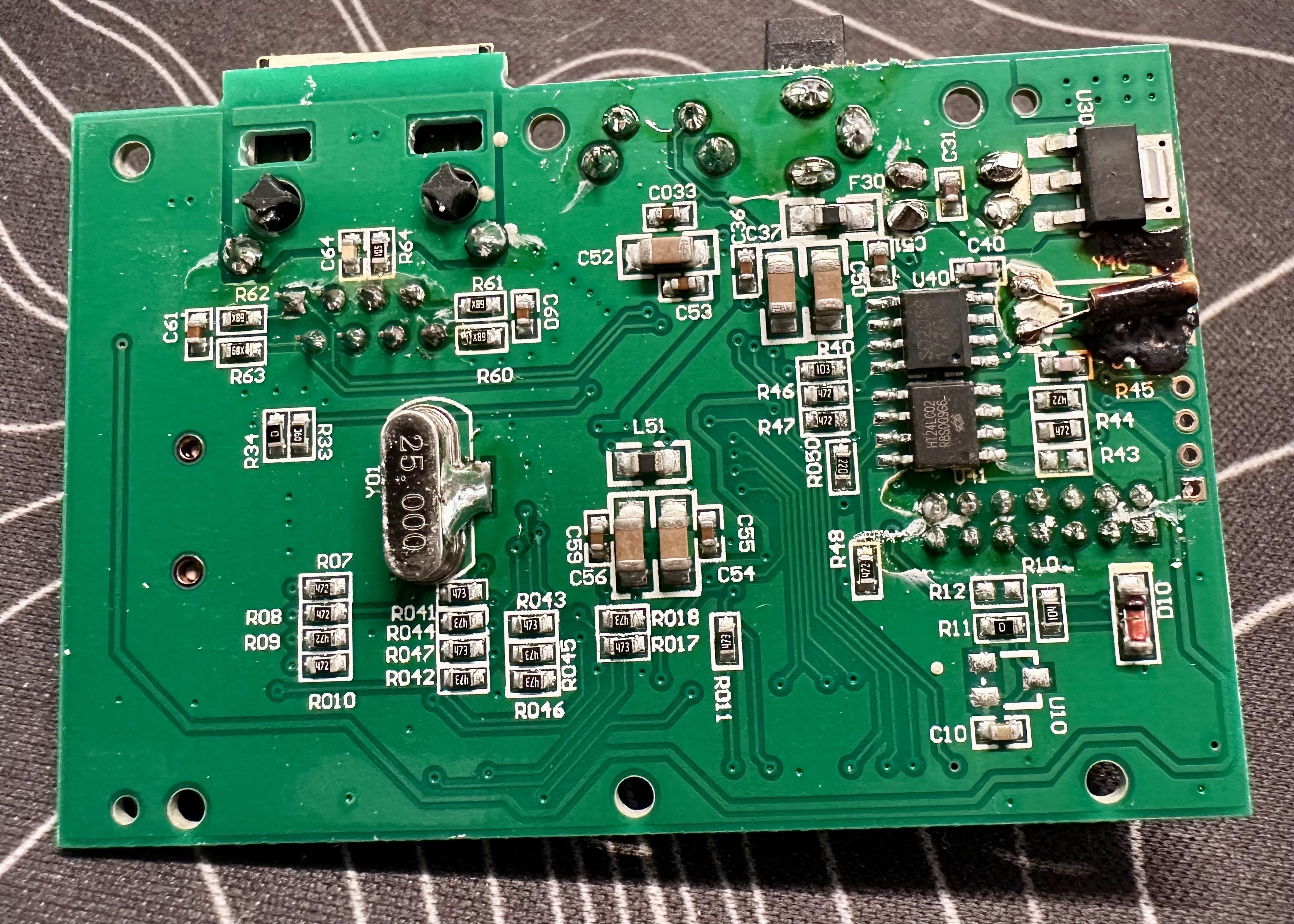 a picture of the bottom of a circuit board from an Ambient Weather ObserverIP unit. towards the top right there is a component that has melted all over the board.
