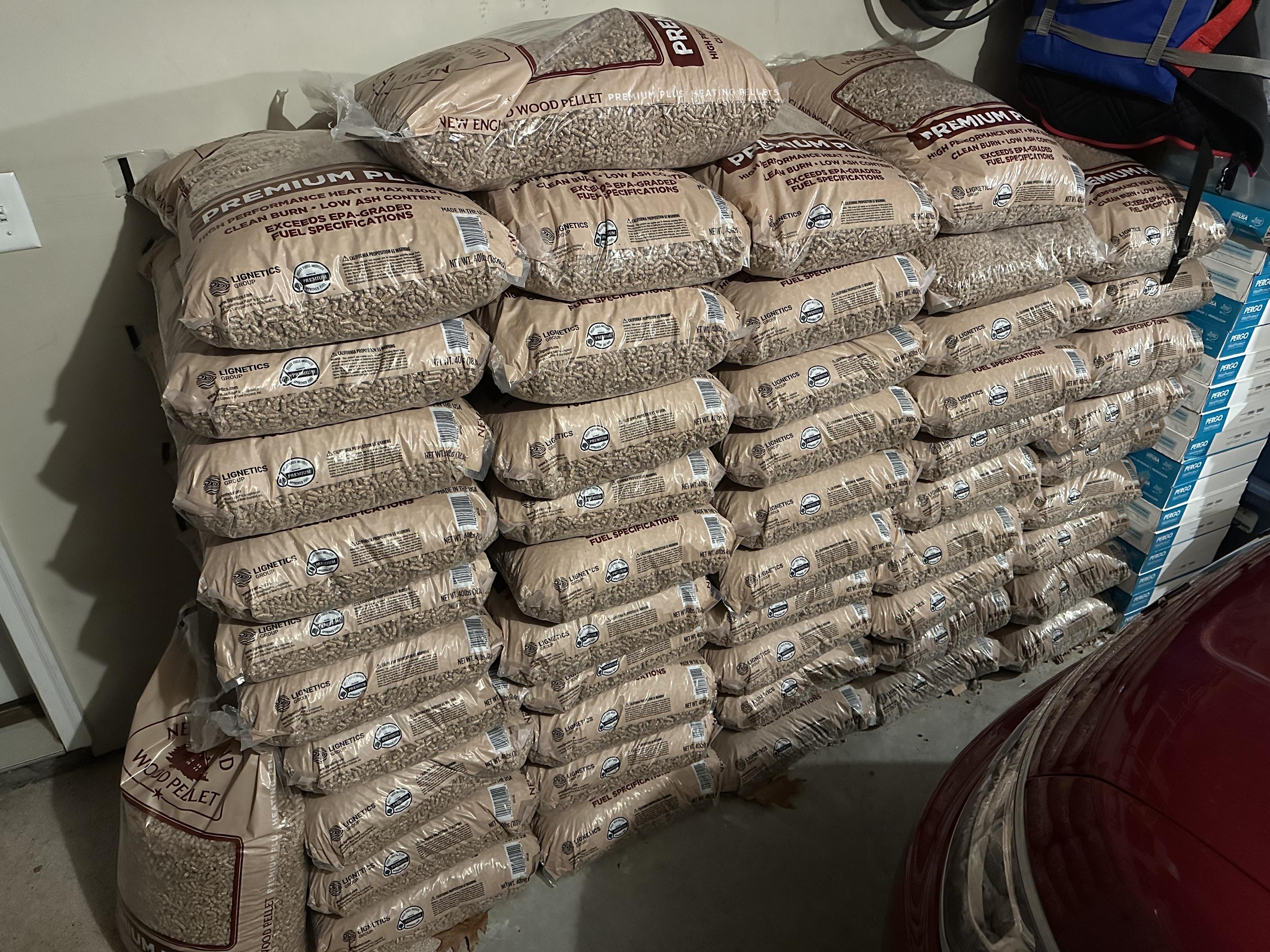 a photo of a ton of wood pellets in 40lb bags stacked in my garage