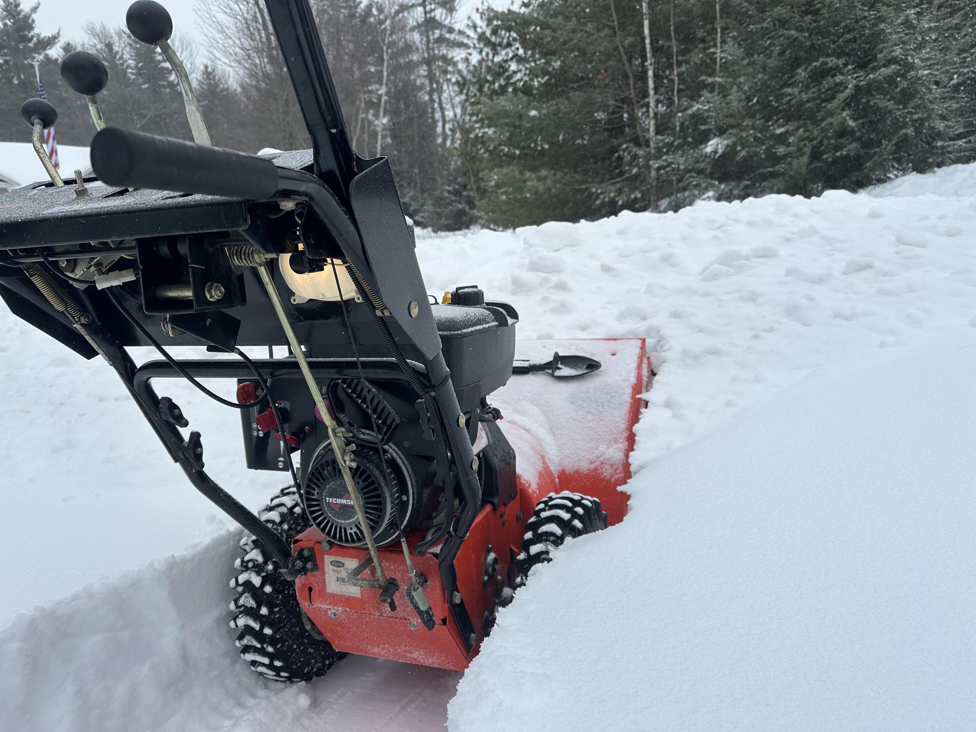 a photo of my snowblower cutting through the pile left by the plow. 