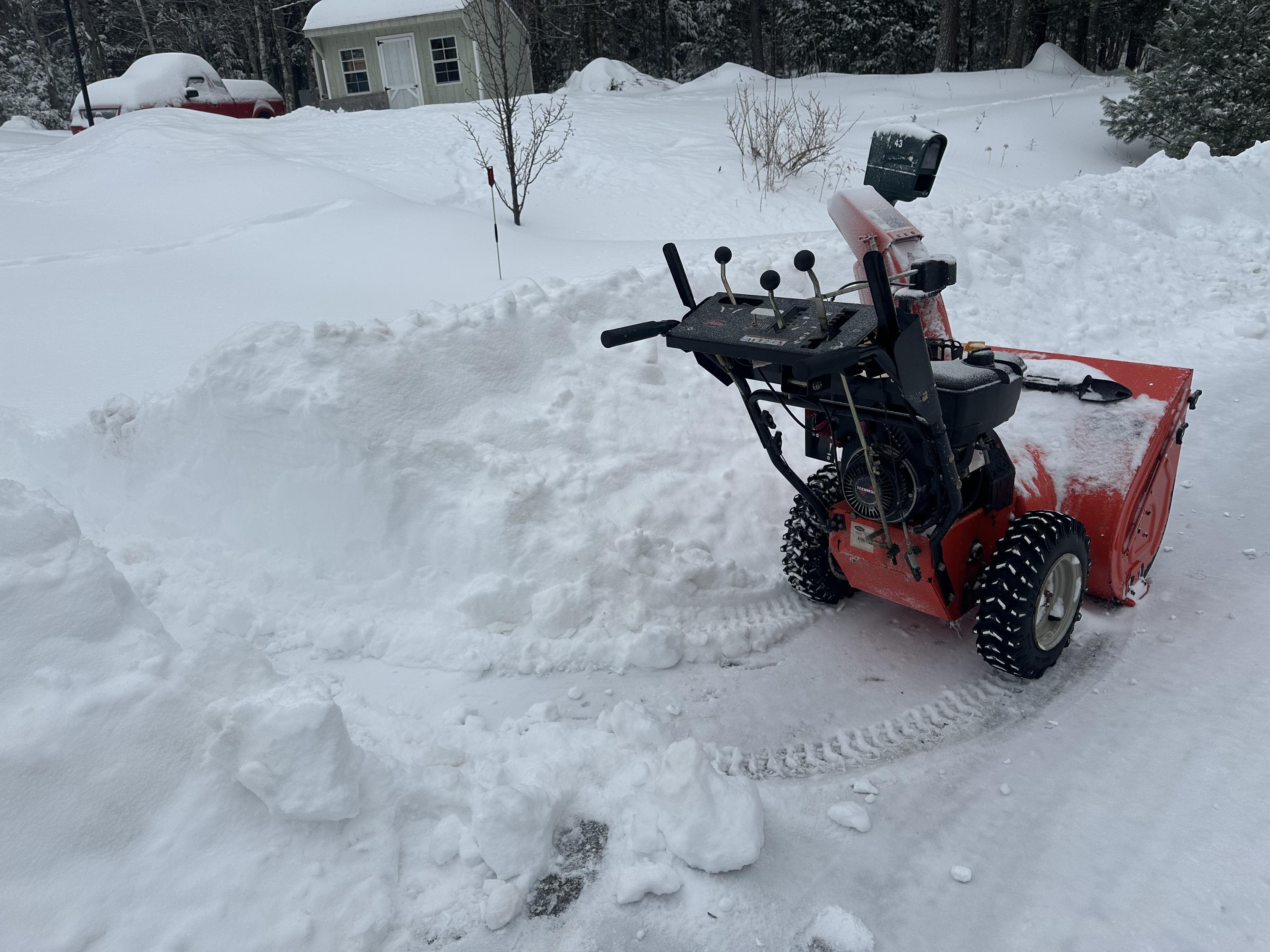a photo of my snowblower in front of the pile left by the plow.