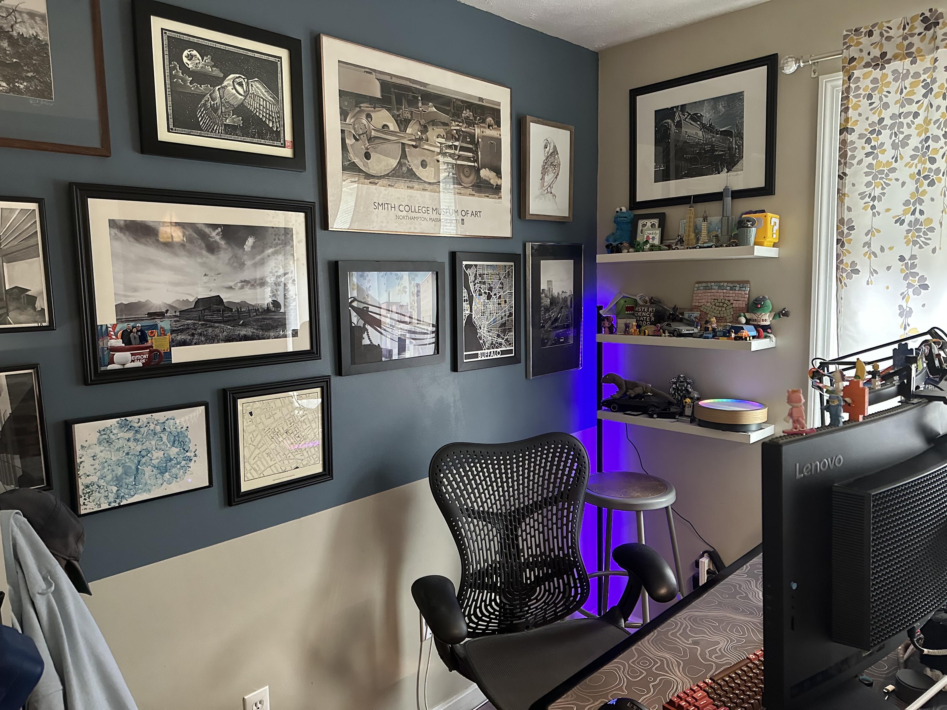 a photo of my office desk area/wall behind it with various photos and prints