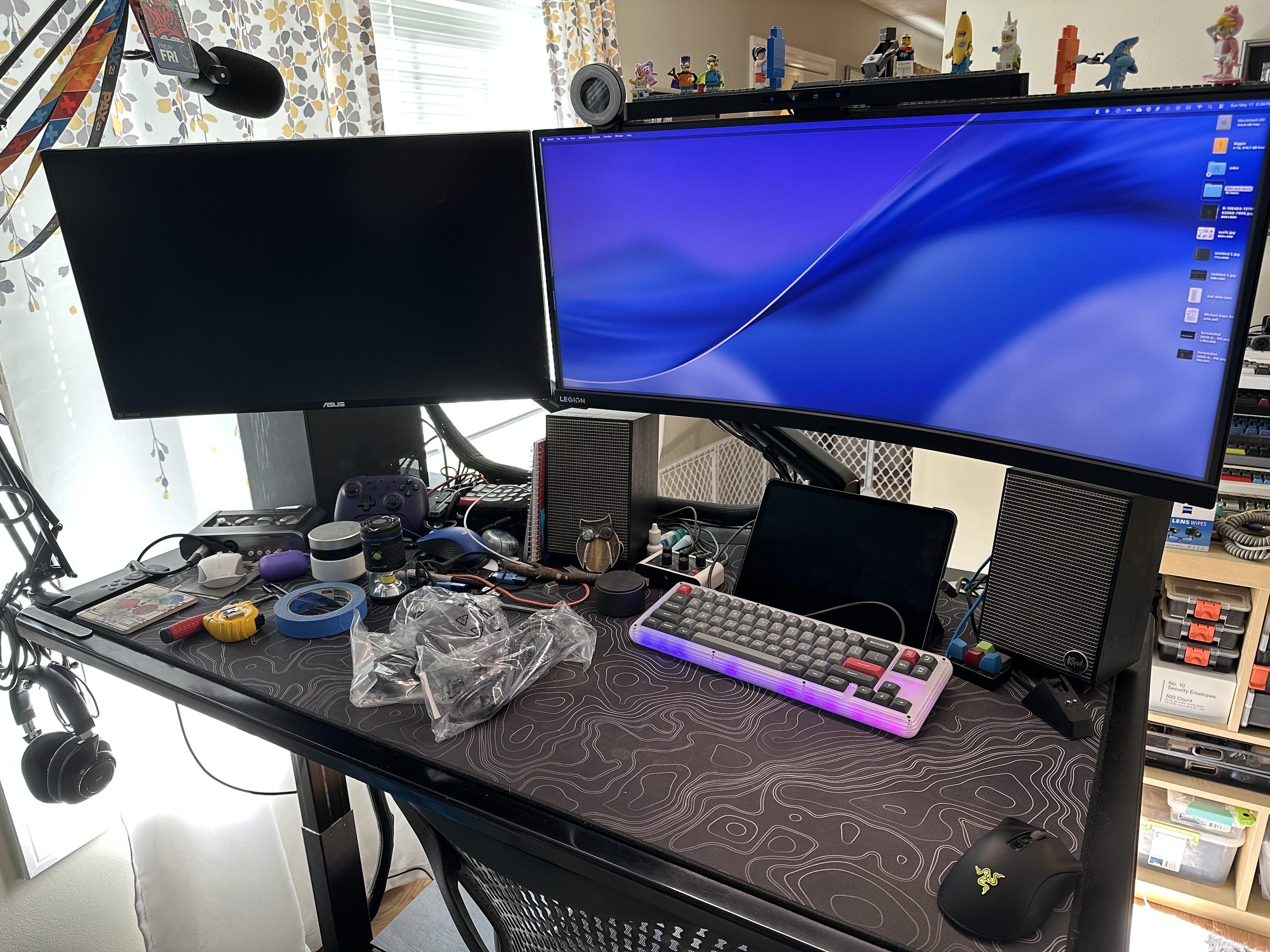a photo of my desk with a 27” monitor mounted alongside a 35” widescreen monitor. it’s a lot. 