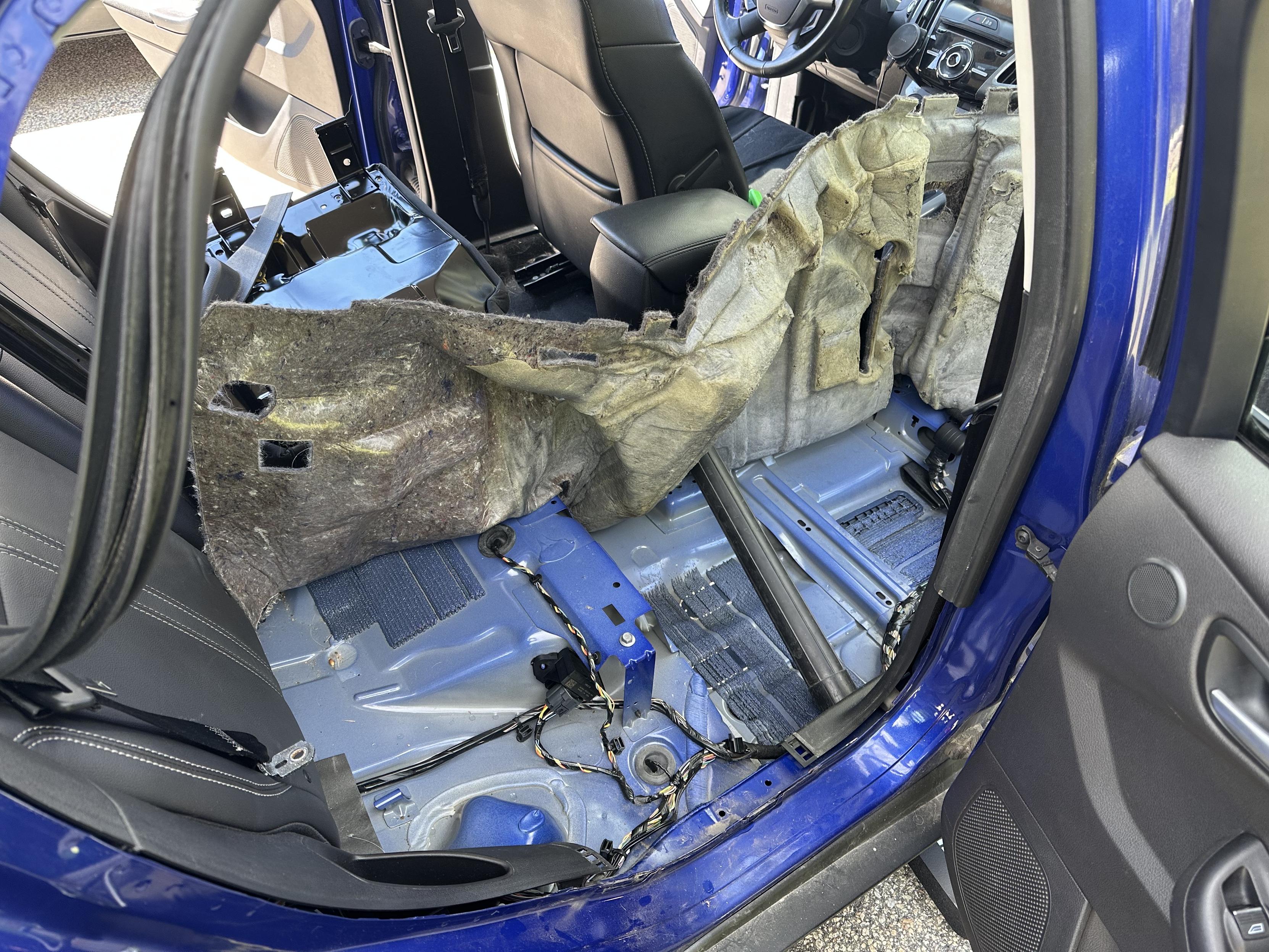 a photo of the interior of my car with the passenger side seats removed and the carpet pulled up