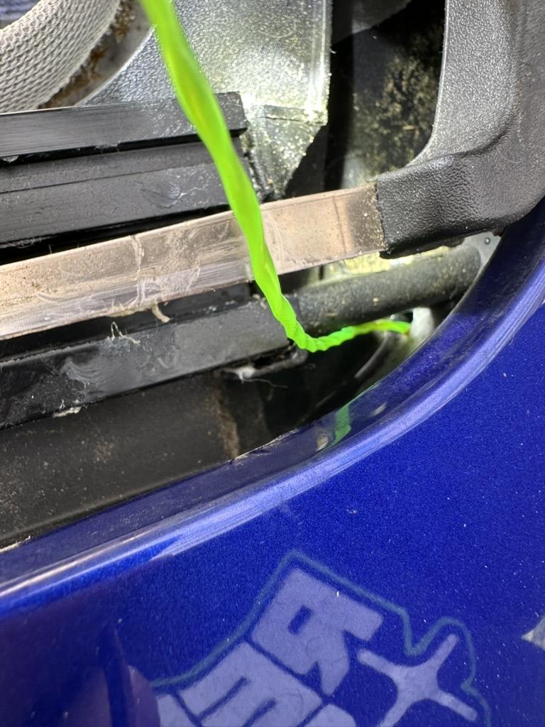 a photo of the sunroof drain on a 2013 ford focus with a piece of weed whacker line inserted into it