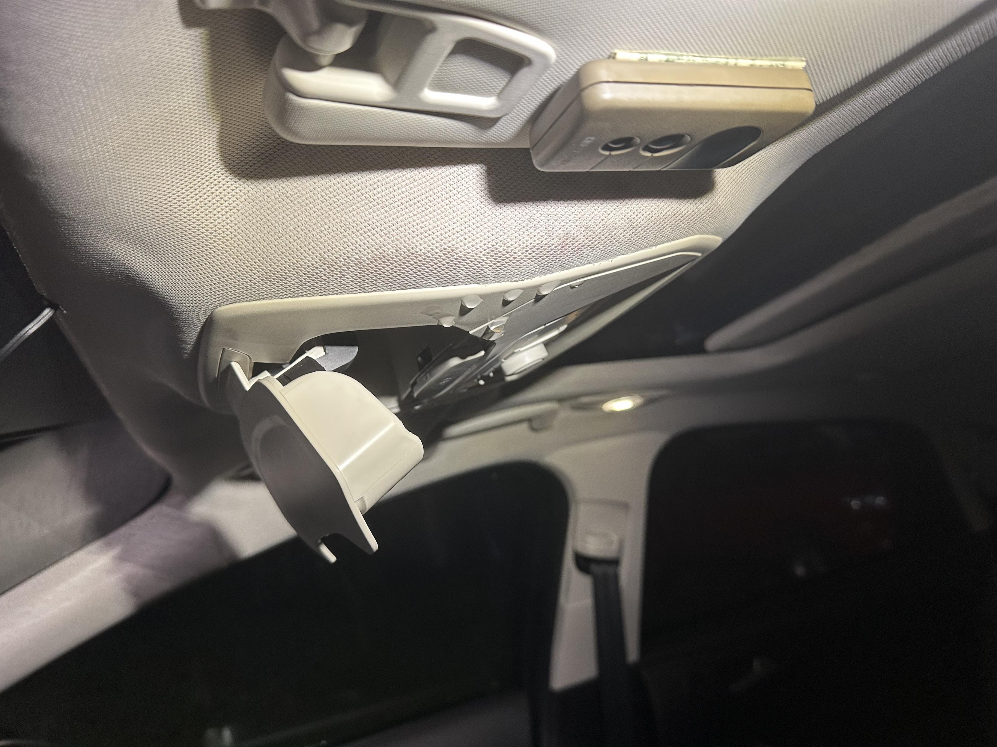a photo of rainwater dripping copiously from my headliner in my car.